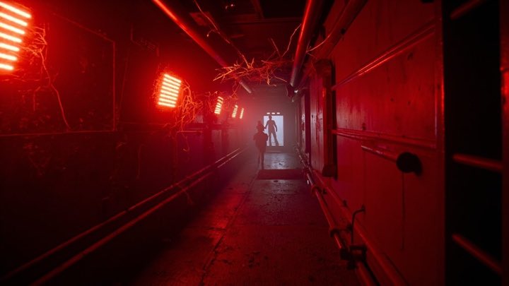 A sabotaged station corridor lit crimson by emergency lighting, sparks and shadows.